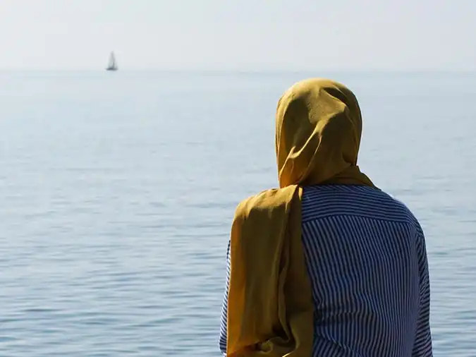muslim woman gazing at ocean