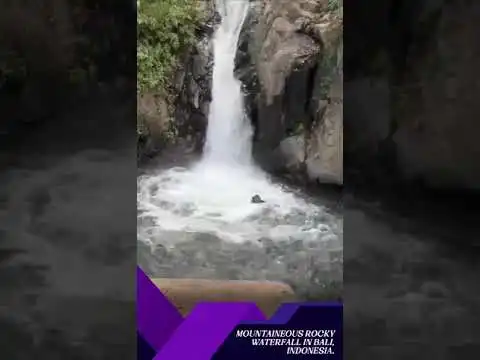 shaikh fariq naik dares to slide on a mountaineous rocky waterfall in bali, indonesia